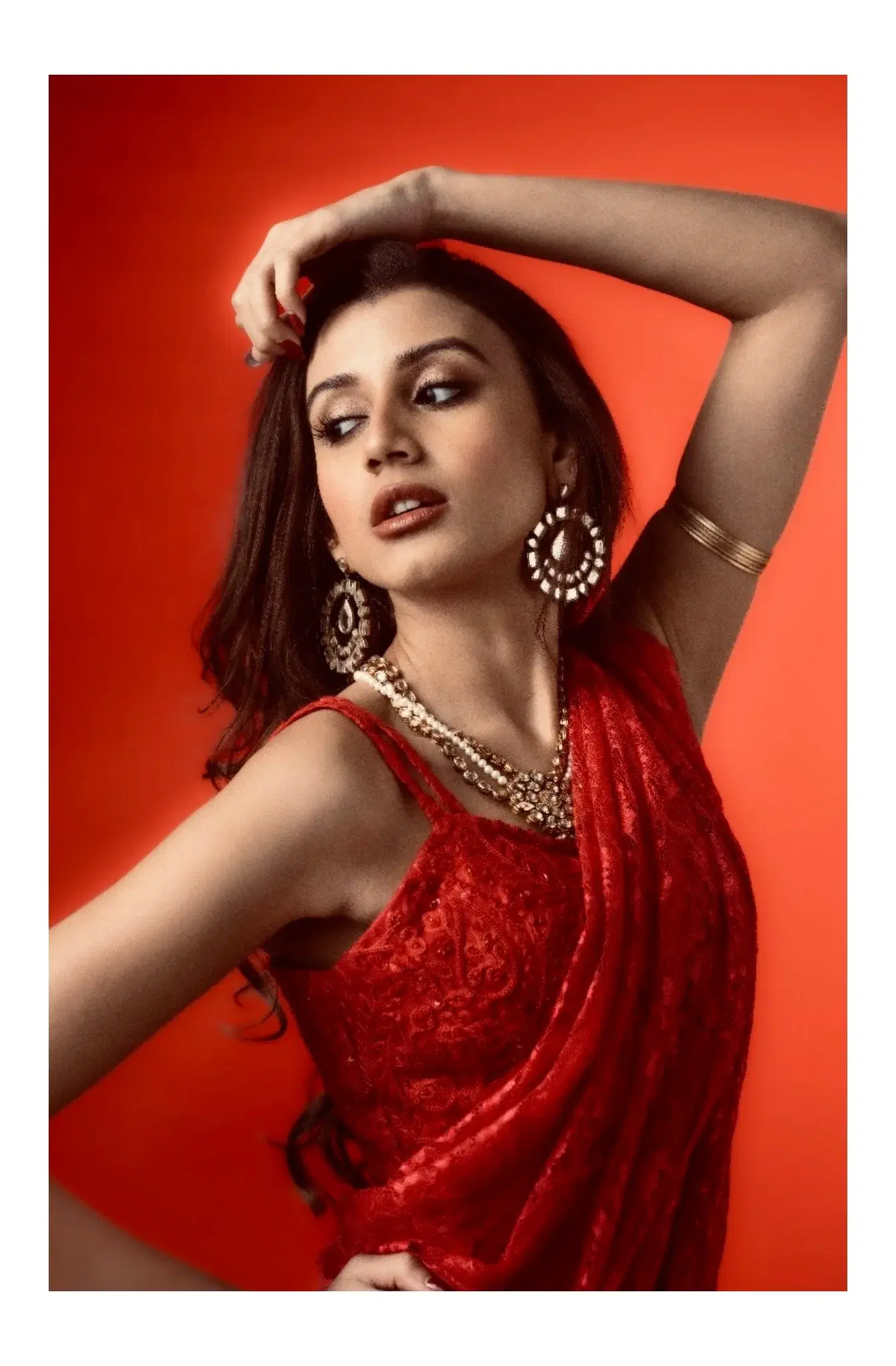Close fashion portrait in red with statement earrings