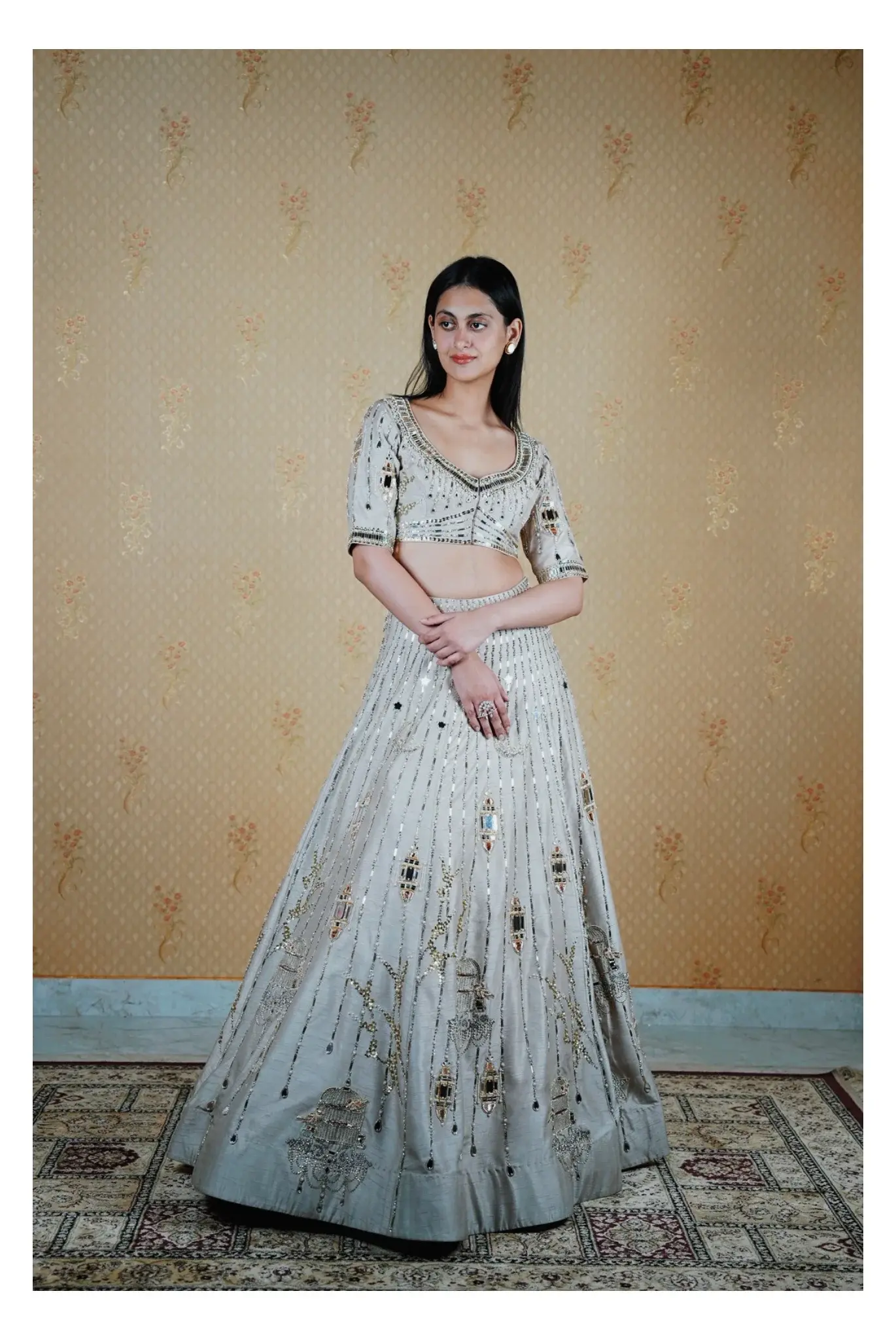Full-length portrait in a pale embroidered gown