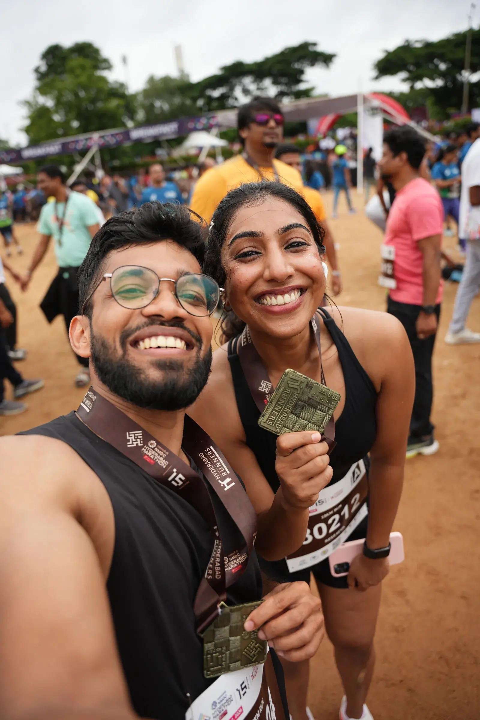 Two smiling runners pose together after the race