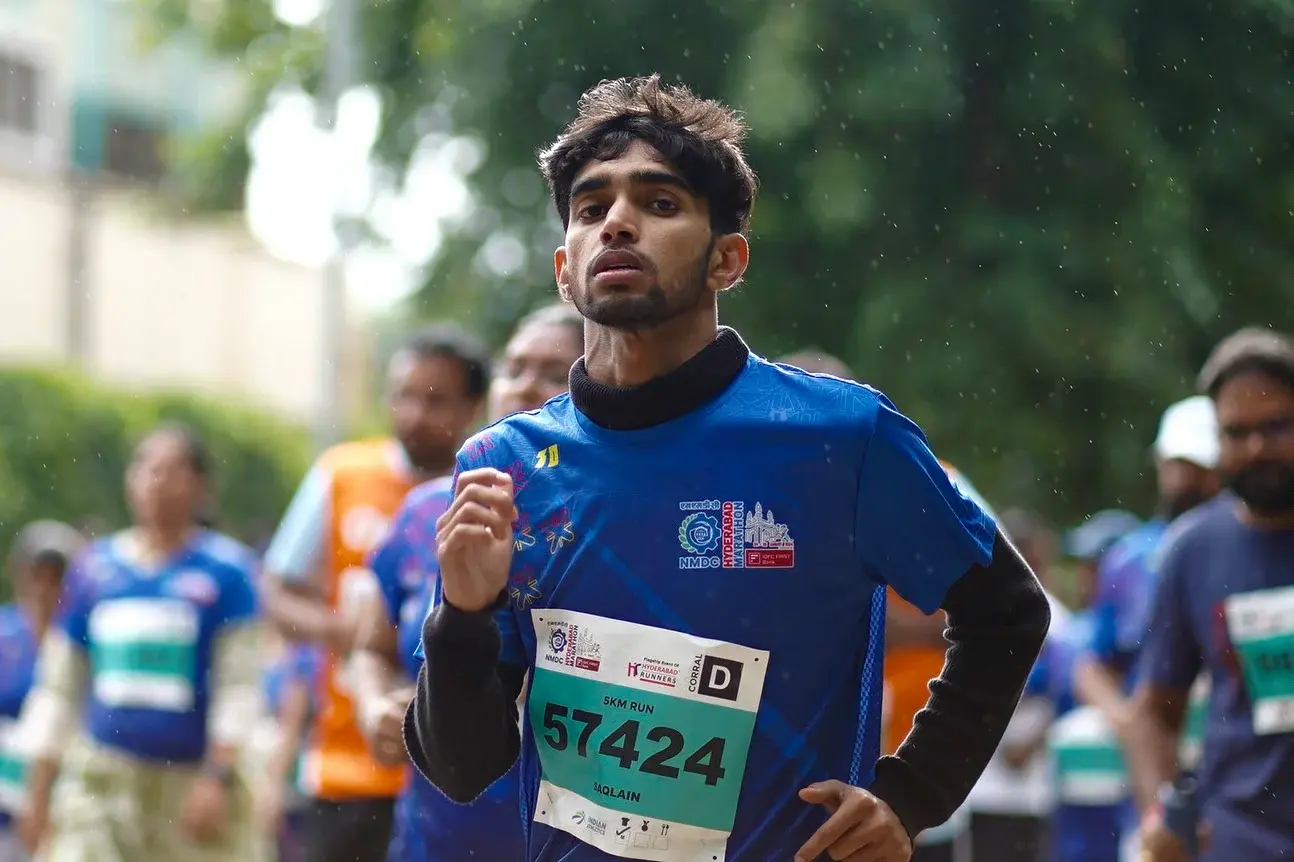 Close portrait of a runner in a blue race shirt